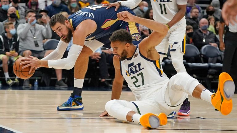 New Orleans Pelicans' Jonas Valanciunas, left, reaches for the ball as Utah Jazz center Rudy Gobert (27) falls to the floor in the first half of a preseason NBA basketball game Monday, Oct. 11, 2021, in Salt Lake City. (Rick Bowmer/AP)