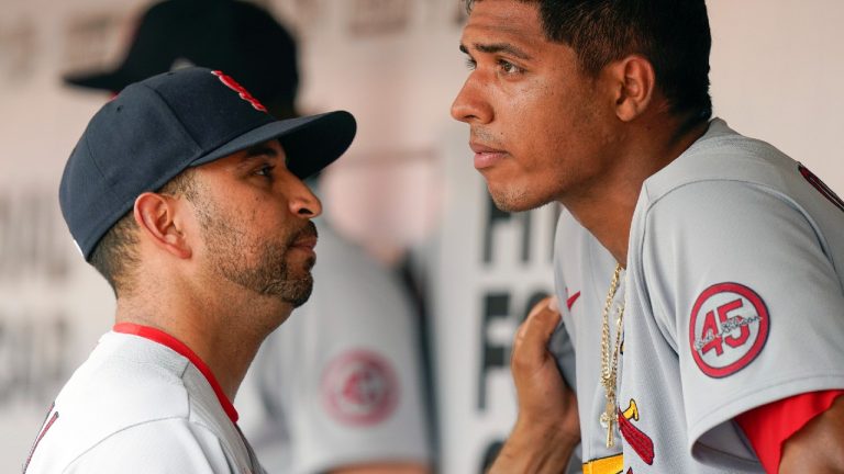 St. Louis Cardinals' bench coach Oliver Marmol talks to starting pitcher Johan Oviedo after he left the game in the fifth inning of a baseball game against the Cincinnati Reds in Cincinnati, Sunday, July 25, 2021 (Bryan Woolston/AP).