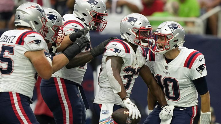 New England Patriots running back Damien Harris (37) celebrates his touchdown run with quarterback Mac Jones (10) and teammates. (Eric Christian Smith/AP)