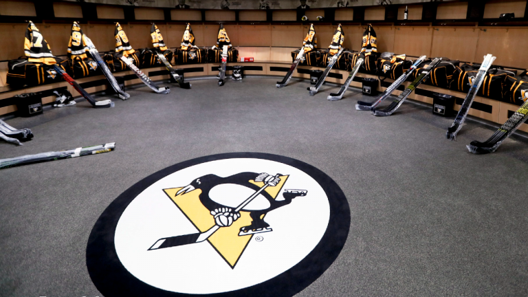 The team logo is in the center of the Pittsburgh Penguins locker room before players come in. (Keith Srakocic/AP)