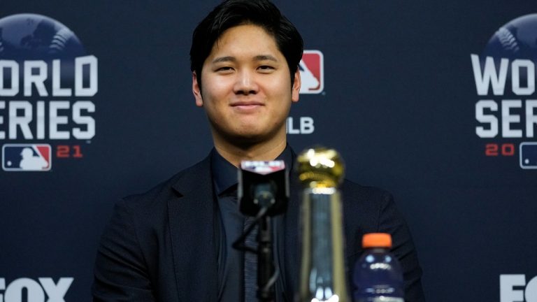 Shohei Ohtani wins the Commissioner's Historic Achievement Award from Rob Manfred before Game 1 in baseball's World Series between the Houston Astros and the Atlanta Braves Tuesday, Oct. 26, 2021, in Houston (Ashley Landis/AP).