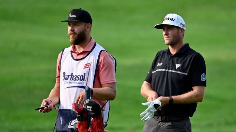 Taylor Pendrith, right, talks to his caddie before hitting his approach shot to the ninth hole during the third round of the Barbasol Championship golf tournament at Keene Trace in Nicholasville, Ky., Saturday, July 17, 2021 (Timothy D. Easley/AP).