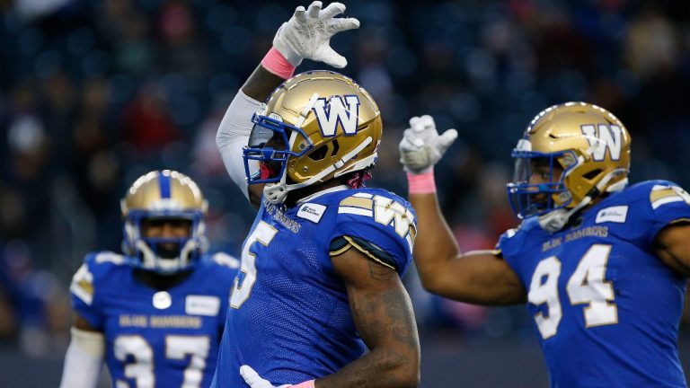 Winnipeg Blue Bombers' Willie Jefferson (5) and Jackson Jeffcoat (94) celebrate their sack of B.C. Lions quarterback Mike Reilly (not shown) during the first half of CFL action in Winnipeg Saturday, October 23, 2021. (John Woods/The Canadian Press)
