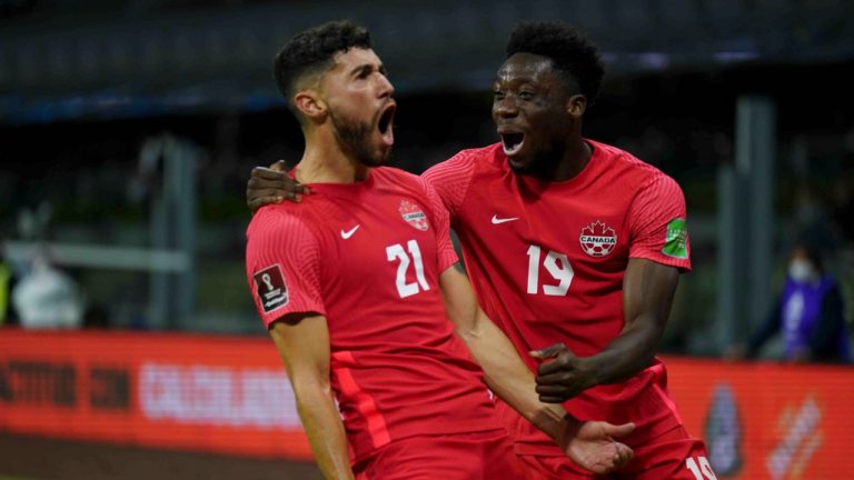 Canada's Jonathan Osorio, left, celebrates scoring his side's first goal against Mexico during a qualifying soccer match for the FIFA World Cup Qatar 2022, at Azteca stadium in Mexico City, Thursday, Oct. 7, 2021. (Fernando Llano/AP Photo) 
