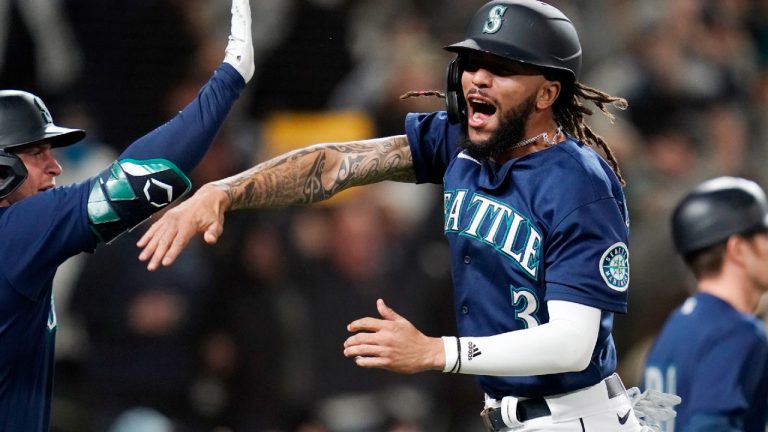 Seattle Mariners' J.P. Crawford celebrates after scoring against the Los Angeles Angels in the eighth inning of a baseball game Saturday, Oct. 2, 2021, in Seattle. (Elaine Thompson/AP)