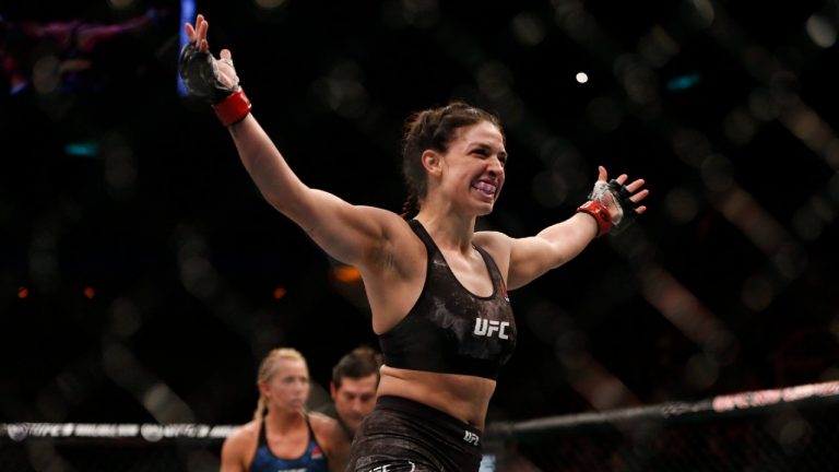 Mackenzie Dern, from the United States, celebrates after defeating countrywoman Amanda Cooper during their UFC women's strawweight mixed martial arts bout in Rio de Janeiro, Brazil, early Sunday, May 13, 2018. (Leo Correa/AP)