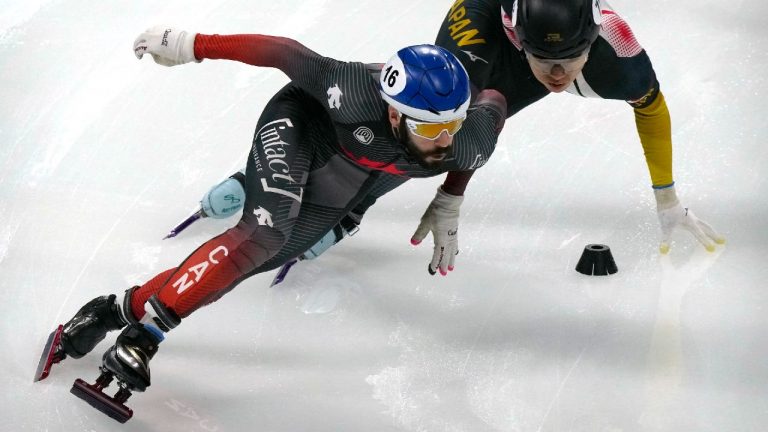 Steven Dubois of Canada, left, and Kota Kikuchi of Japan compete in a ranking final of the men's 500m at the ISU World Cup Short Track speed skating competition, a test event for the 2022 Winter Olympics, at the Capital Indoor Stadium in Beijing, Saturday, Oct. 23, 2021. (Mark Schiefelbein/AP)