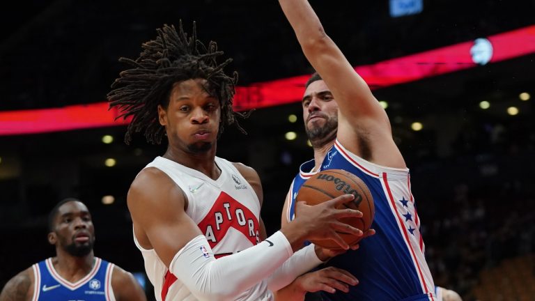 Toronto Raptors forward Freddie Gillespie (55) and Philadelphia 76ers' Georges Niang, right, battle for the ball during first half pre-season NBA basketball action in Toronto on Monday Oct. 4, 2021. (Nathan Denette/The Canadian Press)
