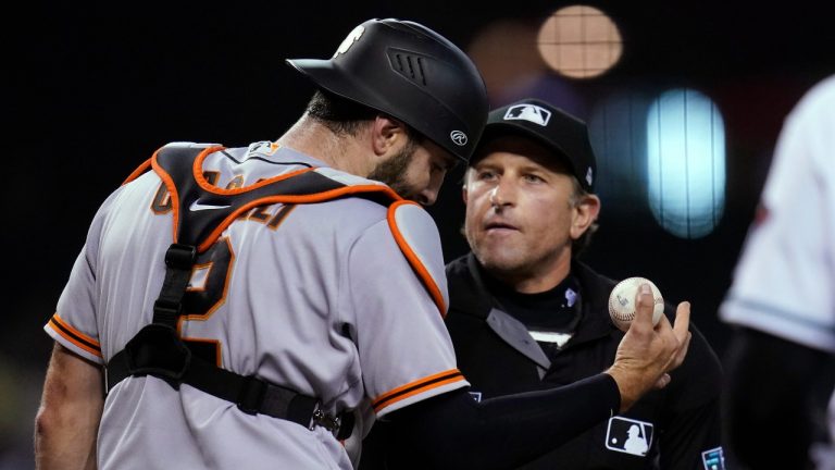 San Francisco Giants catcher Curt Casali, left, argues with umpire Chris Guccione after the umpire called Giants pitcher Johnny Cueto for a balk during the second inning of the team's baseball game against the Arizona Diamondbacks, Tuesday, Aug. 3, 2021, in Phoenix. (Ross D. Franklin/AP Photo) 
