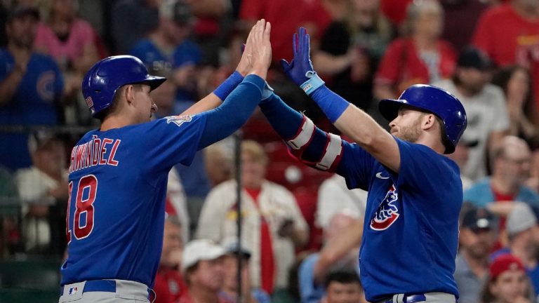 Chicago Cubs' Ian Happ, right, is congratulated by teammate Frank Schwindel after hitting a two-run home run during the ninth inning of a baseball game against the St. Louis Cardinals Saturday, Oct. 2, 2021, in St. Louis. (Jeff Roberson/AP)