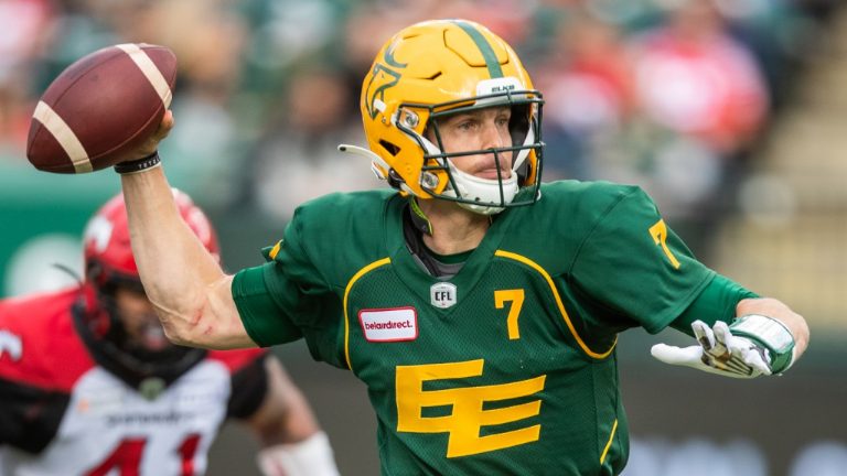 Edmonton Elks' quarterback Trevor Harris (7) passes under pressure from Calgary Stampeders' Mike Rose (41) during first half CFL action in Edmonton, Alta., on Saturday September 11, 2021. (Amber Bracken/CP)