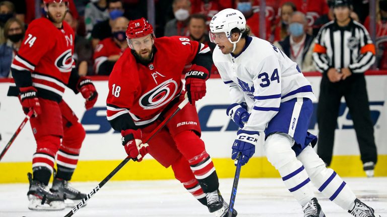 Toronto Maple Leafs' Auston Matthews (34) is pressured by Carolina Hurricanes' Derek Stepan (18) during the second period of an NHL hockey game. (Karl B DeBlaker/AP) 