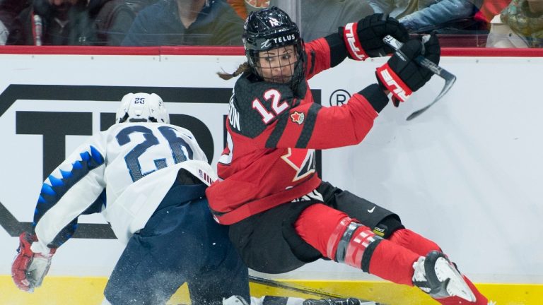 Team Canada's Meaghan Mikkelson fights for control of the puck with U.S.A.'s Kendall Coyne Schofield during first period of Women's Rivalry Series hockey action in Vancouver, Wednesday, February 5, 2020. (Jonathan Hayward/CP)