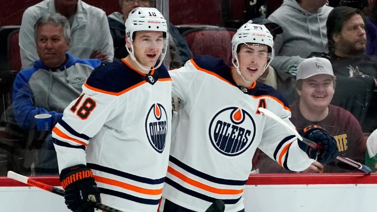 Edmonton Oilers left wing Zach Hyman (18) celebrates his short-handed goal against the Arizona Coyotes with centre Ryan Nugent-Hopkins, right, during the second period of an NHL hockey game Thursday, Oct. 21, 2021, in Glendale, Ariz. (Ross D. Franklin/AP)