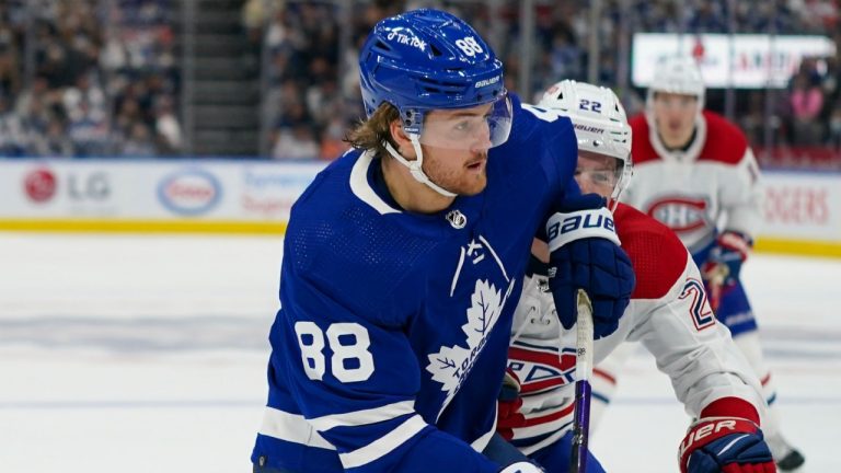 Toronto Maple Leafs forward William Nylander (88) takes a shot on goal while under pressure from Montreal Canadiens forward Cole Caufield (22) during second period NHL action in Toronto on Wednesday, October 13, 2021. (Evan Buhler/CP)