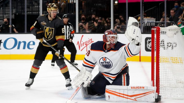 Edmonton Oilers goaltender Mikko Koskinen (19) makes a glove-save as Vegas Golden Knights right wing Evgenii Dadonov (63) looks on during the second period of an NHL hockey game Friday, Oct. 22, 2021, in Las Vegas. (Steve Marcus/AP Photo) 
