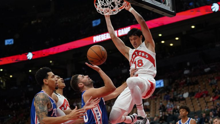 Toronto Raptors forward Yuta Watanabe (18) slam dunks over Philadelphia 76ers' Georges Niang, centre, battle for the ball during first half pre-season NBA basketball action. (Nathan Denette/CP)