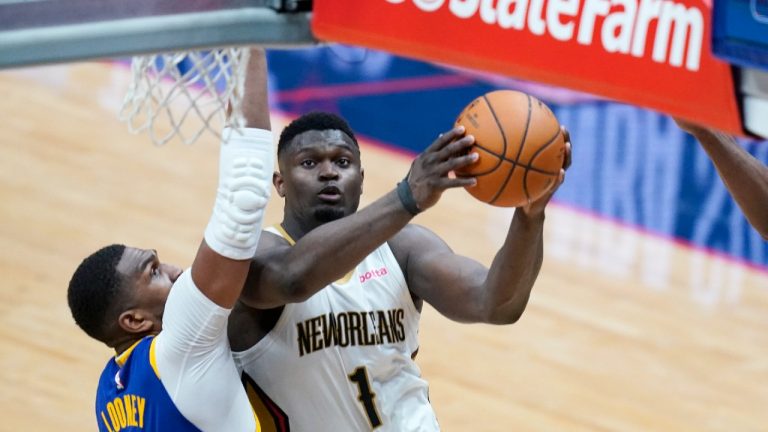 New Orleans Pelicans forward Zion Williamson (1) goes to the basket against Golden State Warriors centre Kevon Looney in the second half of an NBA basketball game. (Gerald Herbert/AP)