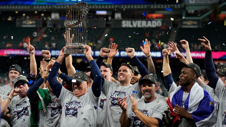 Atlanta Braves manager Brian Snitker holds up the trophy = after winning baseball's World Series in Game 6 against the Houston Astros Tuesday, Nov. 2, 2021, in Houston. The Braves won 7-0. (David J. Phillip/AP)