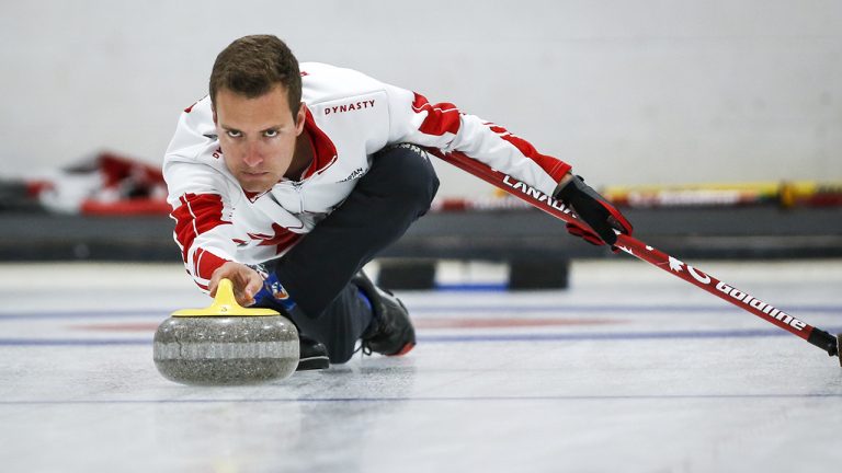 Canada skip Brendan Bottcher makes a shot against Brazil during the Americas Zone Challenge in Lacombe, Alta. (Jeff McIntosh/CP)