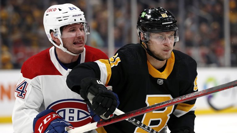 Boston Bruins' Anton Blidh (81) battles Montreal Canadiens' Adam Brooks during the first period of an NHL hockey game. (Winslow Townson/AP)