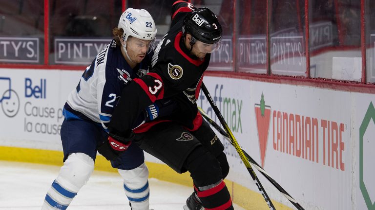 Winnipeg Jets centre Mason Appleton battles with Ottawa Senators defenceman Josh Brown along the boards during the first period NHL action Thursday January 21, 2021 in Ottawa. (Adrian Wyld/CP)