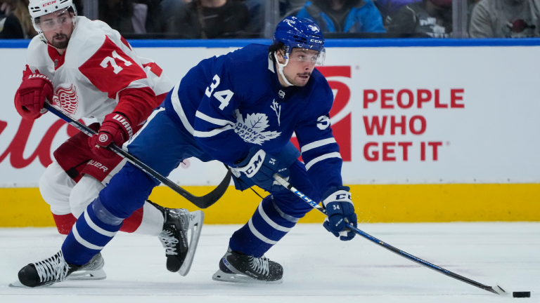 Toronto Maple Leafs forward Auston Matthews avoids a check against Detroit Red Wings forward Dylan Larkin. CP/file)