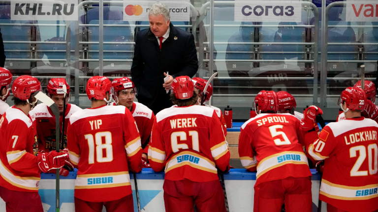 Kunlun Red Star players listen to their team coach during the Kontinental Hockey League ice hockey match between Kunlun Red Star Beijing and Amur Khabarovsk in Mytishchi, just outside Moscow, Russia on Monday. Many of Kunlun Red Star's players are aiming to represent the Chinese national team at the Olympics in Beijing. (AP)