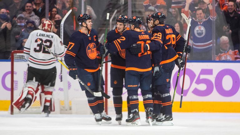 Chicago Blackhawks goalie Kevin Lankinen (32) looks on as the Edmonton Oilers players celebrate a goal during first period NHL action in Edmonton on Saturday, November 20, 2021. (Jason Franson/CP)