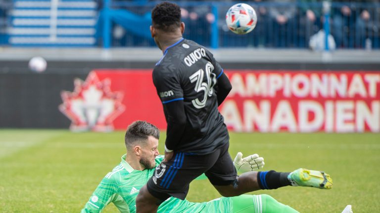 CF Montreal's Romell Quioto moves in on Toronto FC's goalkeeper Quentin Westberg during fist half Canadian Championship soccer action in Montreal, Sunday, November 21, 2021. (Graham Hughes/CP)