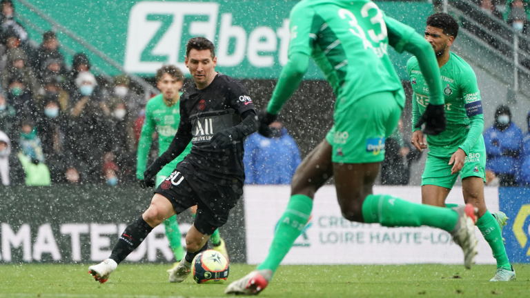 PSG's Lionel Messi, left, challenges for the ball with Saint-Etienne' players during the French League One soccer between Saint-Etienne and Paris Saint Germain, in Saint-Etienne, France, on Sunday. (AP)