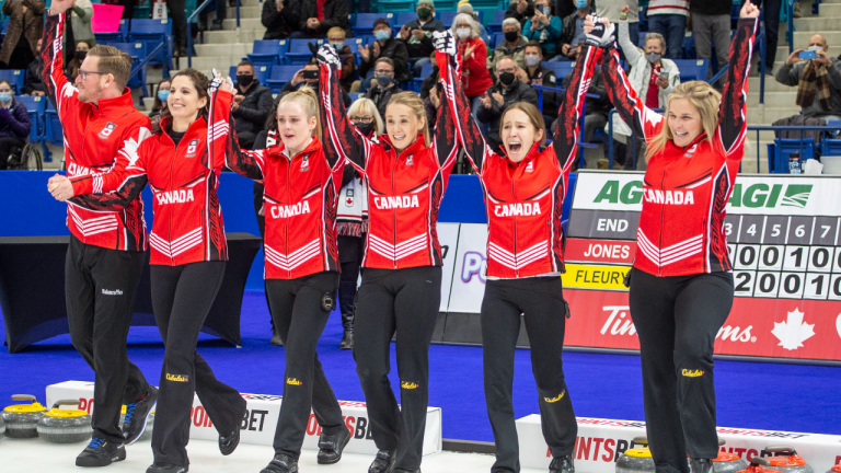 Team Jones skip Jennifer Jones and team celebrate after receiving their Team Canada Jackets during woman's final of the 2021 Canadian Olympic curling trials in Saskatoon on Sunday. (CP)