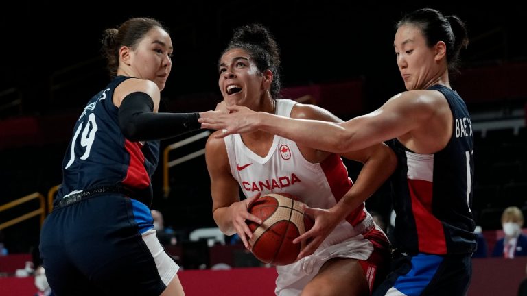 Canada's Kia Nurse (5), center, drives between South Korea's Ji Su Park (19), left, and Hyeyoon Bae (11) during women's basketball preliminary round game at the 2020 Summer Olympics, Thursday, July 29, 2021, in Saitama, Japan. (Eric Gay/AP)