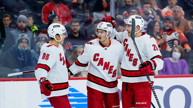 Carolina Hurricanes' Teuvo Teravainen (86), Sebastian Aho (20) and Ian Cole (28) celebrate after Aho's goal during the first period of an NHL hockey game against the Philadelphia Flyers, Friday, Nov. 26, 2021, in Philadelphia. (Matt Slocum/AP) 