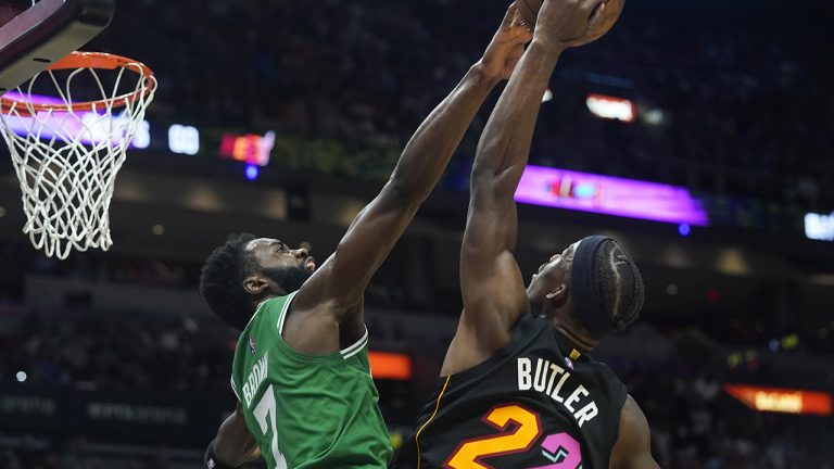 Boston Celtics guard Jaylen Brown (7) blocks a shot to the basket by Miami Heat forward Jimmy Butler (22) during the first half of an NBA basketball game. (Marta Lavandier/AP)