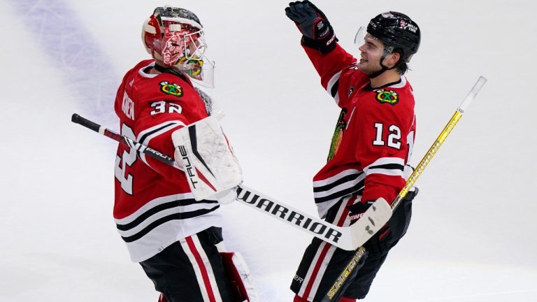 Chicago Blackhawks left wing Alex DeBrincat, right, celebrates with goaltender Kevin Lankinen after scoring the game-winning goal against the Nashville Predators during an overtime period of an NHL hockey game in Chicago, Sunday, Nov. 7, 2021. The Chicago Blackhawks won 2-1 in overtime (Nam Y. Huh/AP).