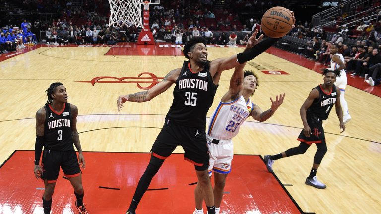 Houston Rockets centre Christian Wood (35) grabs a rebound from Oklahoma City Thunder guard Tre Mann (23) during the second half of an NBA basketball game. (Eric Christian Smith/AP)