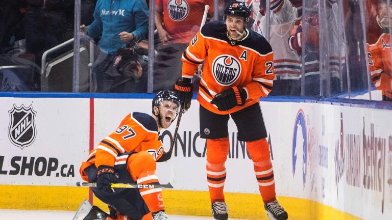 Edmonton Oilers' Connor McDavid (97) and Leon Draisaitl (29) celebrate a goal against the New York Rangers during third period NHL action in Edmonton on Friday, November 5, 2021 (Jason Franson/CP).