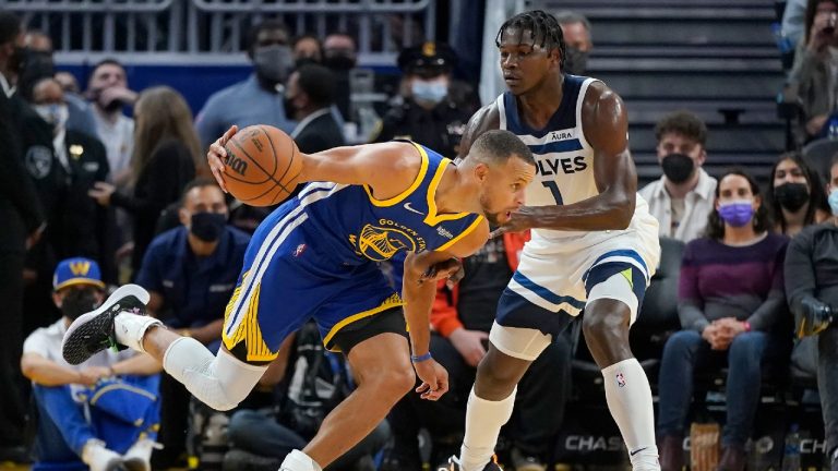 Golden State Warriors guard Stephen Curry, left, drives to the basket against Minnesota Timberwolves forward Anthony Edwards during the first half of an NBA basketball game in San Francisco, Wednesday, Nov. 10, 2021. (Jeff Chiu/AP) 