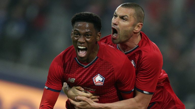 Lille's scorer Jonathan David, left, celebrates with teammate Burak Yilmaz, right, after scoring the opening goal during the Champions League group G soccer match between OSC Lille and RB Salzburg at the Stade Pierre Mauroy - Villeneuve d'Ascq in Lille, France, Tuesday, Nov. 23, 2021. (Michel Spingler/AP)