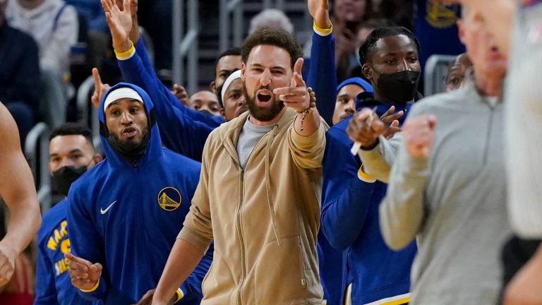 Injured Golden State Warriors' Klay Thompson, center, gestures during the second half of an NBA basketball game against the Oklahoma City Thunder in San Francisco, Saturday, Oct. 30, 2021. (Jeff Chiu/AP) 