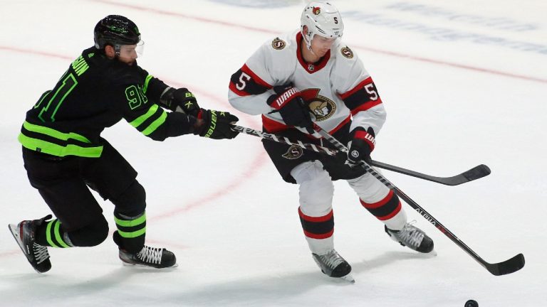 Ottawa Senators defenseman Nick Holden (5) works around the stick of Dallas Stars center Tyler Seguin (91) during the second period of an NHL hockey game Friday, Oct. 29, 2021, in Dallas (Ray Carlin/AP).