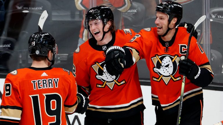 Anaheim Ducks forwards Troy Terry, left, Ryan Getzlaf, right, and defenseman Josh Manson celebrate a goal by Terry during the third period of an NHL hockey game against the Montreal Canadiens, Sunday, Oct. 31, 2021, in Anaheim, Calif. (Ringo H.W. Chiu/AP).