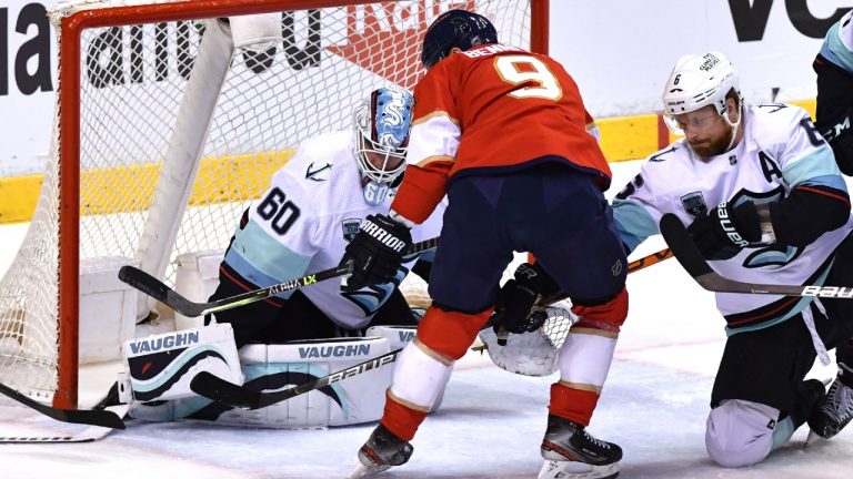 Florida Panthers center Sam Bennett (9) tries to get a shot away as Seattle Kraken goaltender Chris Driedger (60) and defenseman Adam Larsson (6) close in on the puck during the first period of an NHL hockey game Saturday, Nov. 27, 2021, in Sunrise, Fla (Jim Rassol/AP).