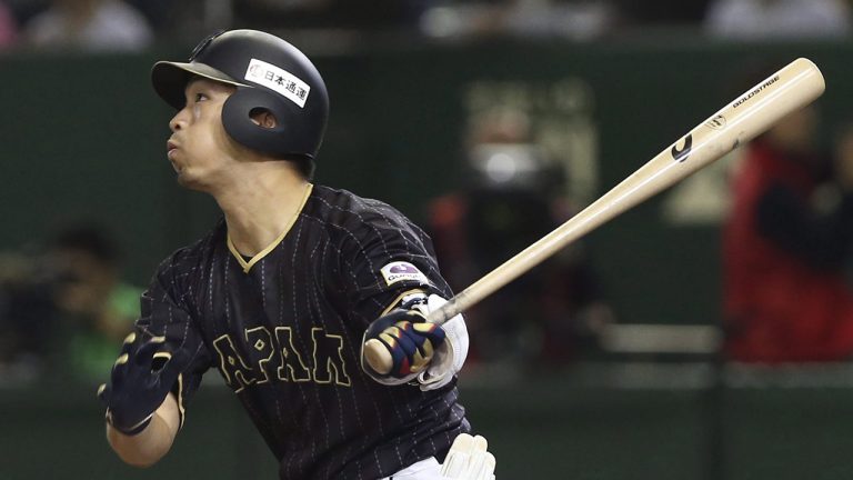 Japan's Seiya Suzuki watches the flight of his grand slam off Netherlands' Jim Ploeger in the 10th inning of their international exhibition series baseball game at Tokyo Dome. (Toru Takahashi/AP)