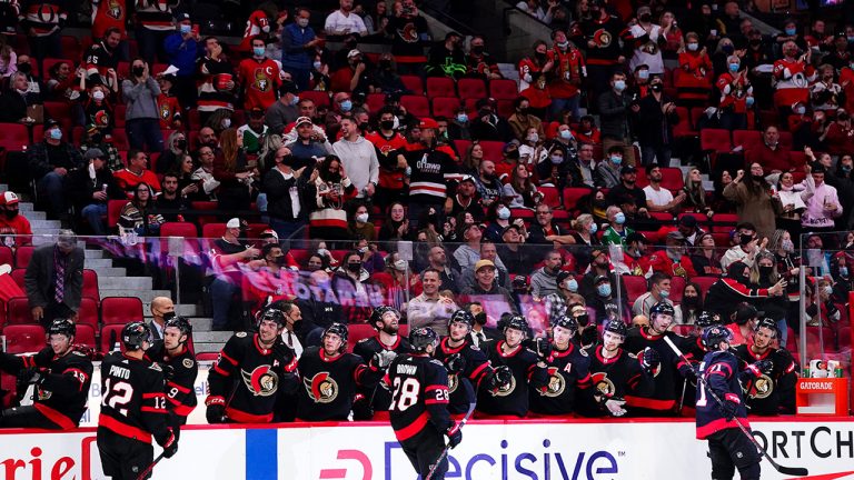 Ottawa Senators' Chris Tierney (71), bottom right, celebrates his second goal against the Dallas Stars as he skate past the bench with teammates while fans look on from the stands during second period NHL action in Ottawa on Sunday, Oct. 17, 2021. (Sean Kilpatrick/CP)