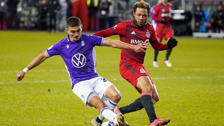 Pacific FC midfielder Manuel Aparicio (34) is defended by Toronto FC midfielder Nick DeLeon (18) during second half Canadian Championship semifinal action in Toronto. (Evan Buhler/CP)