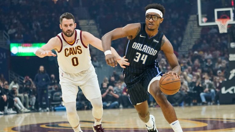 Orlando Magic's Wendell Carter Jr. (34) drives against Cleveland Cavaliers' Kevin Love (0) in the first half of an NBA basketball game, Saturday, Nov. 27, 2021, in Cleveland (Tony Dejak/AP).