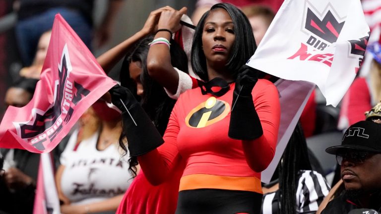 A fan dressed in a Pixar Incredibles Halloween costume watches teams warm up before the first half of an NFL football game between the Atlanta Falcons and the Carolina Panthers in Atlanta. (Mark Humphrey/AP)