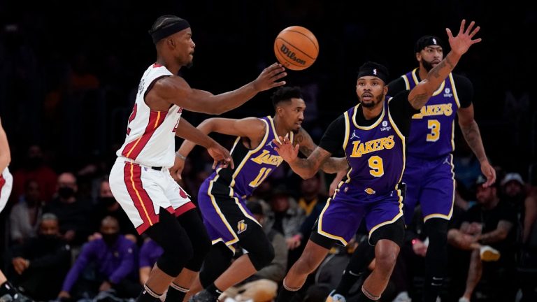 Miami Heat forward Jimmy Butler (22) passes the ball against Los Angeles Lakers forward Kent Bazemore (9) during the first half of an NBA basketball game in Los Angeles, Wednesday, Nov. 10, 2021. (Ashley Landis/AP)